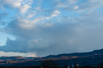Beautiful clouds in sky over valley hills