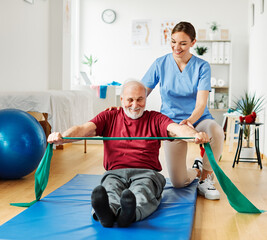 nurse doctor senior care exercise physical therapy exercising help assistence retirement home physiotherapy strech band clinic therapist elderly man - Powered by Adobe