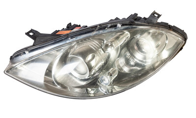 Stylish xenon headlight of a German car - optical equipment with a lamp inside on a white isolated background. Spare part for auto repair in a car workshop