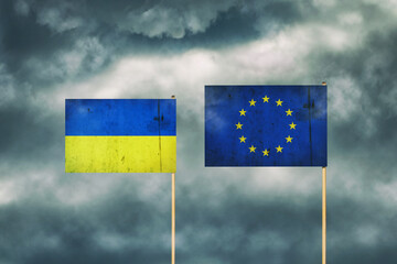 Flag of Ukraine and European Union. Cloudy sky. Politics. Economy