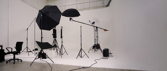 Studio video production lighting set. Behind the scenes shooting production set up by crew team camera and equipment in studio. Video production filming or commercial movie film live streaming online. - obrazy, fototapety, plakaty
