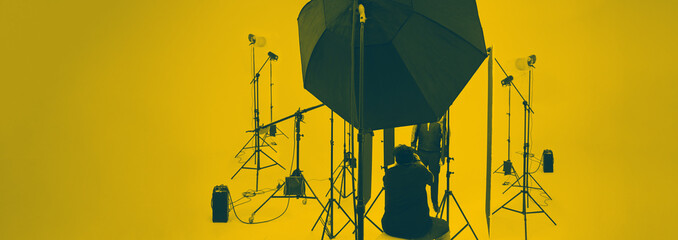 Studio video production lighting set. Behind the scenes shooting production set up by crew team...