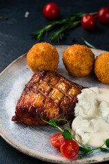 chicken fricassee with fried potatoes, on a black background