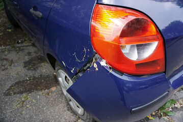 Backside of blue car get damaged by accident.