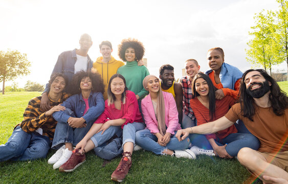 large group of diverse multiracial young people in the park, celebrating life together enjoying happy holidays. lifestyle, travel, togetherness and joy concept