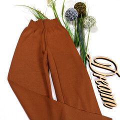 Close-up. Stylish female image. Woolen pants on a white background.