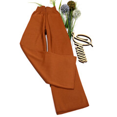 Close-up. Stylish female image. Woolen pants on a white background.