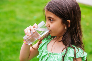 children drink clean water in nature.selective focus