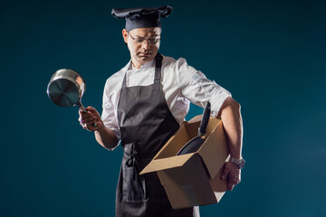 Fired chef. Restaurant's chef has been made redundant. Male cook with box of fired employee....