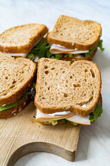 deli meat sandwich with turkey close up shot with selective focus and toast bread.