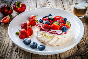 Pavlova meringue cake with cream and strawberries
