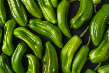 Close up of green peppers. Dark food photo of fresh peppers.