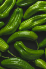 Close up of green peppers. Dark food photo of fresh peppers.