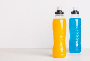 Isotonic energy drink copy space white background. Bottles with blue and yellow water sport...