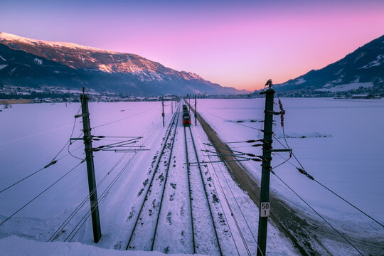 train and winter alpine landscape over morning.