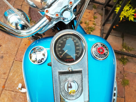 Russia, Sochi 03.07.2021. Blue bright tank with a motorcycle speedometer with a logo and the inscription harley davidson on the street. Closeup photo