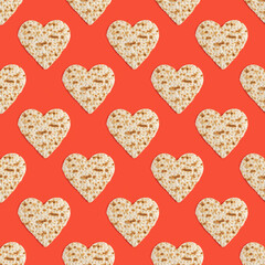 Seamless pattern with matzah in the form of heart for Jewish holiday Pesach on red background.