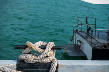 Mooring rope on knot of ferry boat on sea water