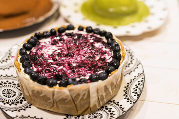 baked blueberry birthday cheesecake on wooden table