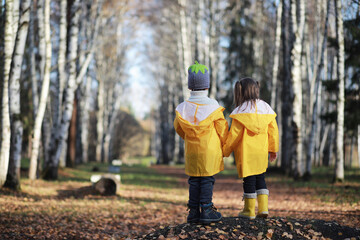 Children walk in the autumn park