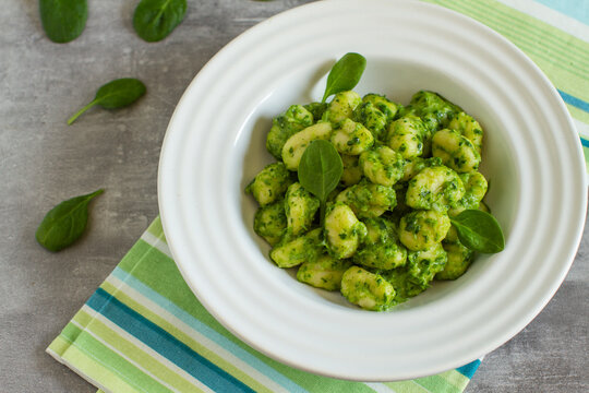 Homemade gnocchi with spinach pesto, healthy mediterranean food