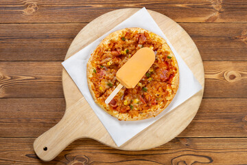 top view fresh chicken and bacon pizza with a chocolate popsicle on top