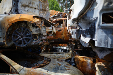 A lot of rusty burnt cars in Irpen, after being shot by the Russian military. Russia's war against Ukraine. Cemetery of destroyed cars of civilians who tried to evacuate from the war zone