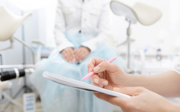 Young woman patient at gynecologist appointment consults in medical institution