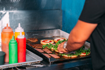 Unknown person preparing some delicious hamburgers on a griddle