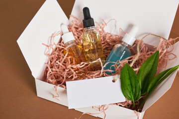 set of cosmetics and body care products in box with paper filler, gift or delivery, natural cosmetics, CO2 neutral