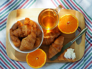 Breakfast with pastries, oranges and tea