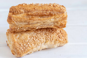 Potato Bourekas on white wooden background with copy space. Israeli Savory Potato Pastries.