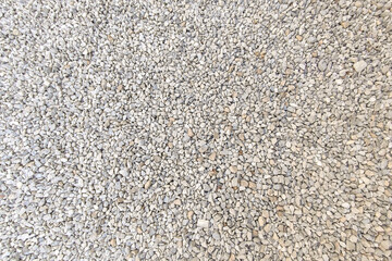 Small gravel road. Pebble background. Crushed stone texture. Gravel rock closeup