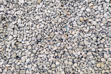 Small gravel road. Pebble background. Crushed stone texture. Gravel rock closeup