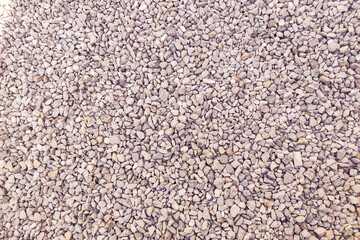 Small gravel road. Pebble background. Crushed stone texture. Gravel rock closeup
