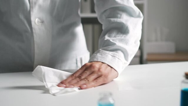 disinfection of the working surface of the workplace cleaning of the table surface sterile working conditions. Medical officer female hands close-up disinfect table surface
