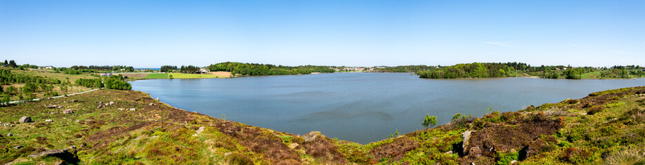 Fototapeta na wymiar Panorama of the southern side of Halandsvatnet lake from a hill viewpoint, Stavanger, Norway, May 2018