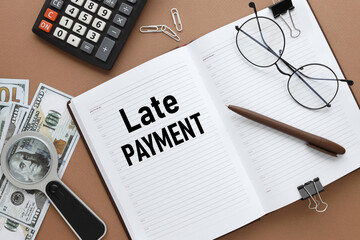 Late Payment. Business concept. inscription on an open notepad, on a wooden table near dollar bills...