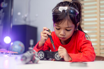 Asia students learn at home in coding robot cars and electronic board cables in STEM, STEAM, mathematics engineering science technology computer code in robotics for kids concept.