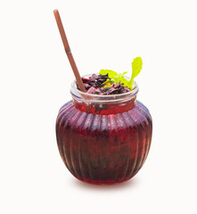 Okra juice or roselle juice dark red in round glass with straw brown. Isolated on white background. Mint leaves and dried okra flowers sprinkled on top of glass. It is natural herbal drink from Asia.