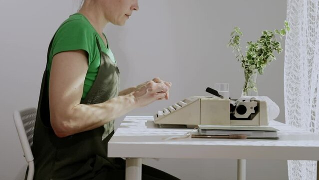 Female playwright is typing a text early in the morning. Closeup