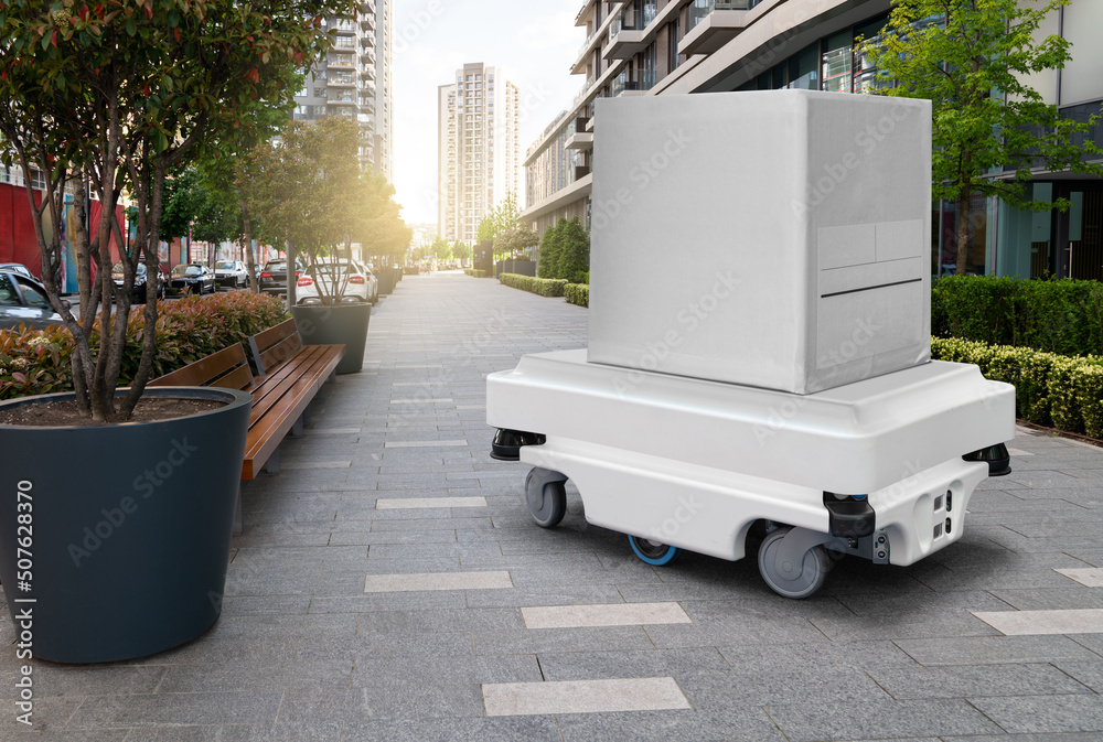 Poster delivery robot transporting a box on the street. concept