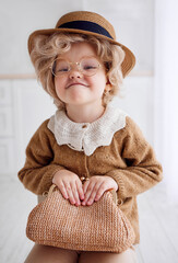 portrait of cute baby girl cosplaying a grumpy old lady. carnival costume party