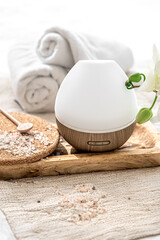 Modern oil aroma diffuser close up on a blurred background.