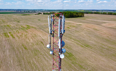 Aerial view of the tower of mobile communications, telecommunications and the 5g Internet. An iron head with locators and antennas. 25 May 2022, Minsk, Belarus
