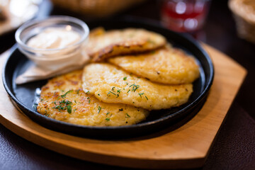 Fried grated potato pancakes with sour cream