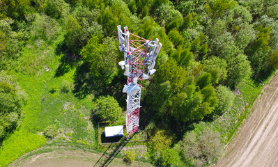 Aerial view of the tower of mobile communications, telecommunications and the 5g Internet. An iron head with locators and antennas. 25 May 2022, Minsk, Belarus