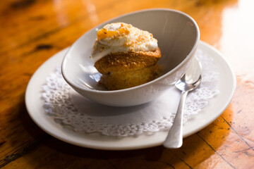 Homemade carrot cake with orange crumbs on plate close-up