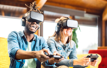 Millenial couple playing with vr glasses at home couch - Virtual reality and tech concept with enthusiastic friends having fun on headset goggles - Generation z digital trends - Bright vivid filter