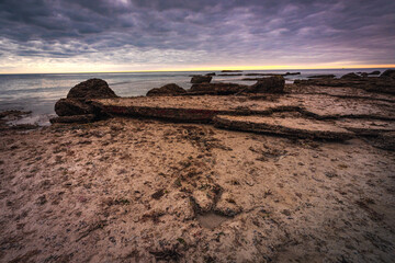 Beautiful sky and sunset with dinosaur footprints at Gantheaume point in Broome, Western Australia